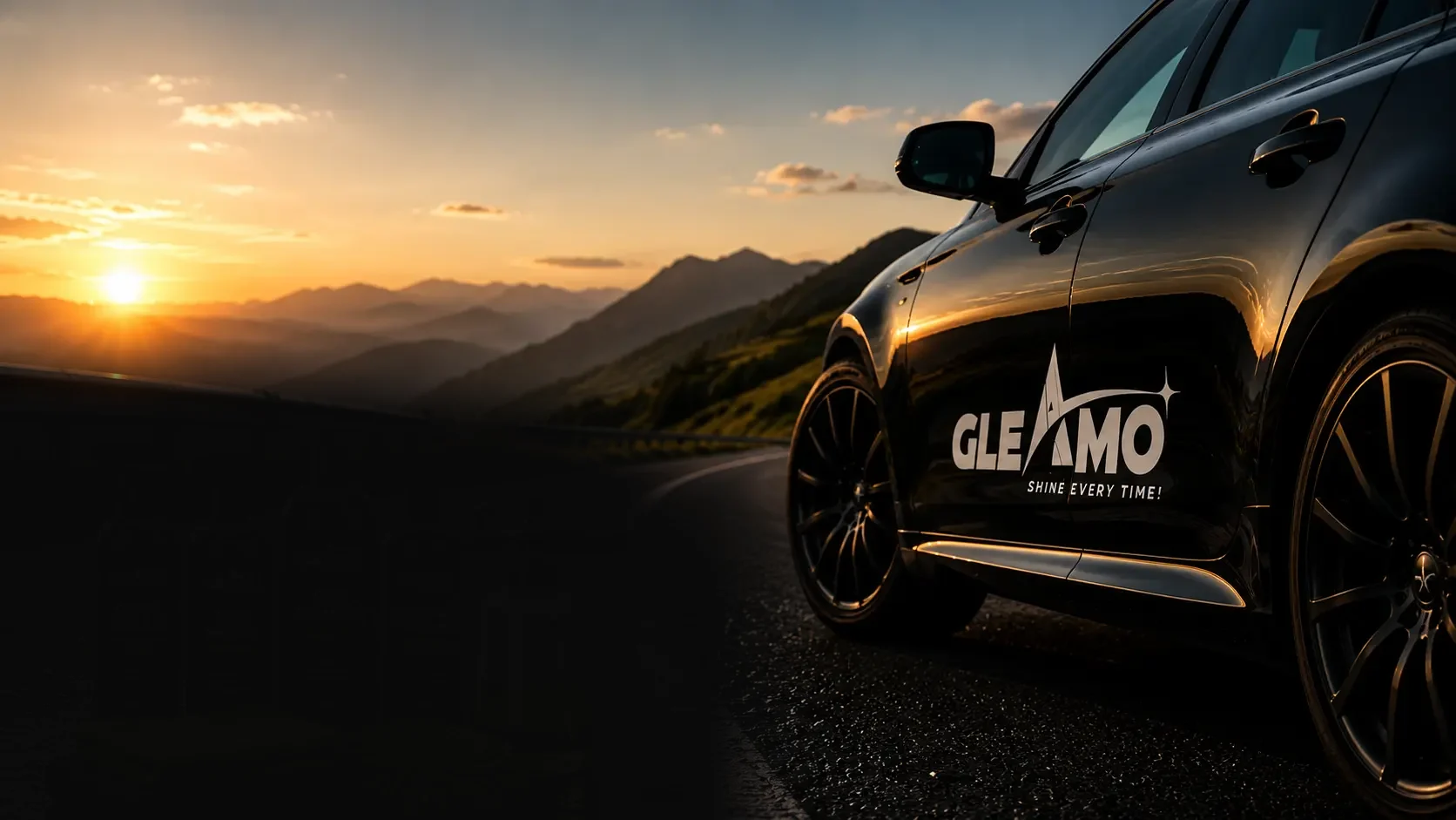 Black Gleamo car on a mountain road at sunset
